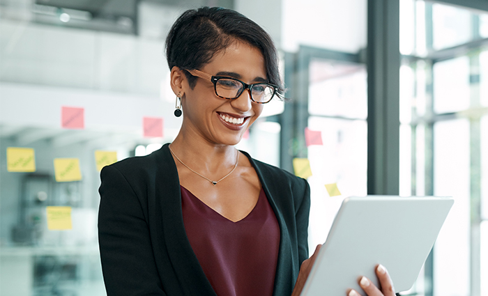 Woman at standing up looking at tablet