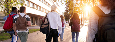 students on campus with backpacks